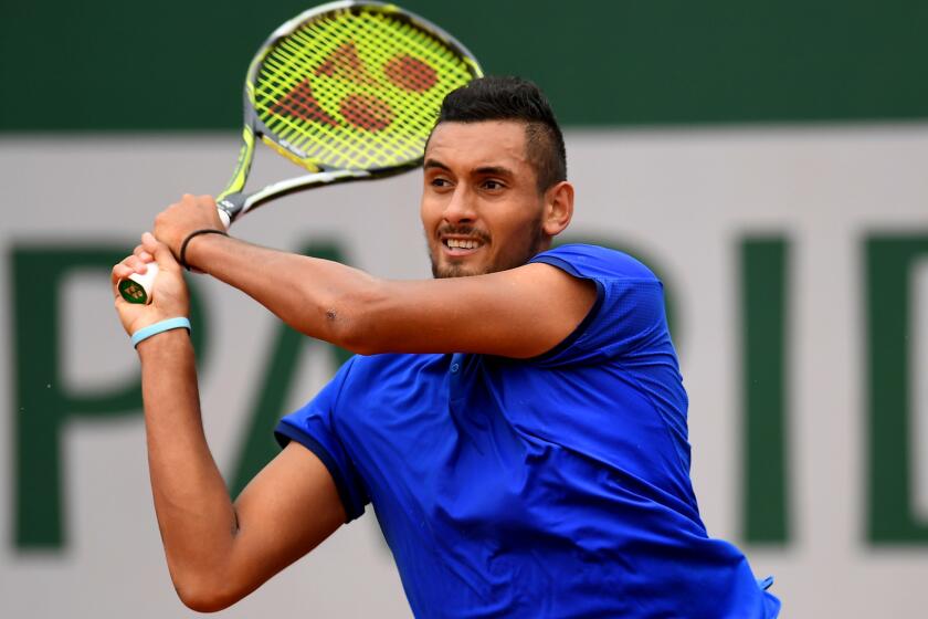 Nick Kyrgios follows through on a shot against Marco Cecchinato at the French Open on Sunday.