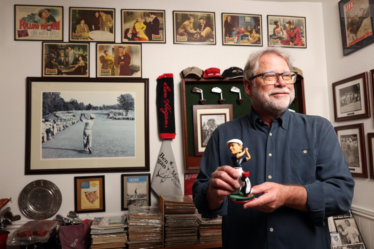 Mark Baron poses with some of his Ben Hogan memorabilia at his home in El Cajon.