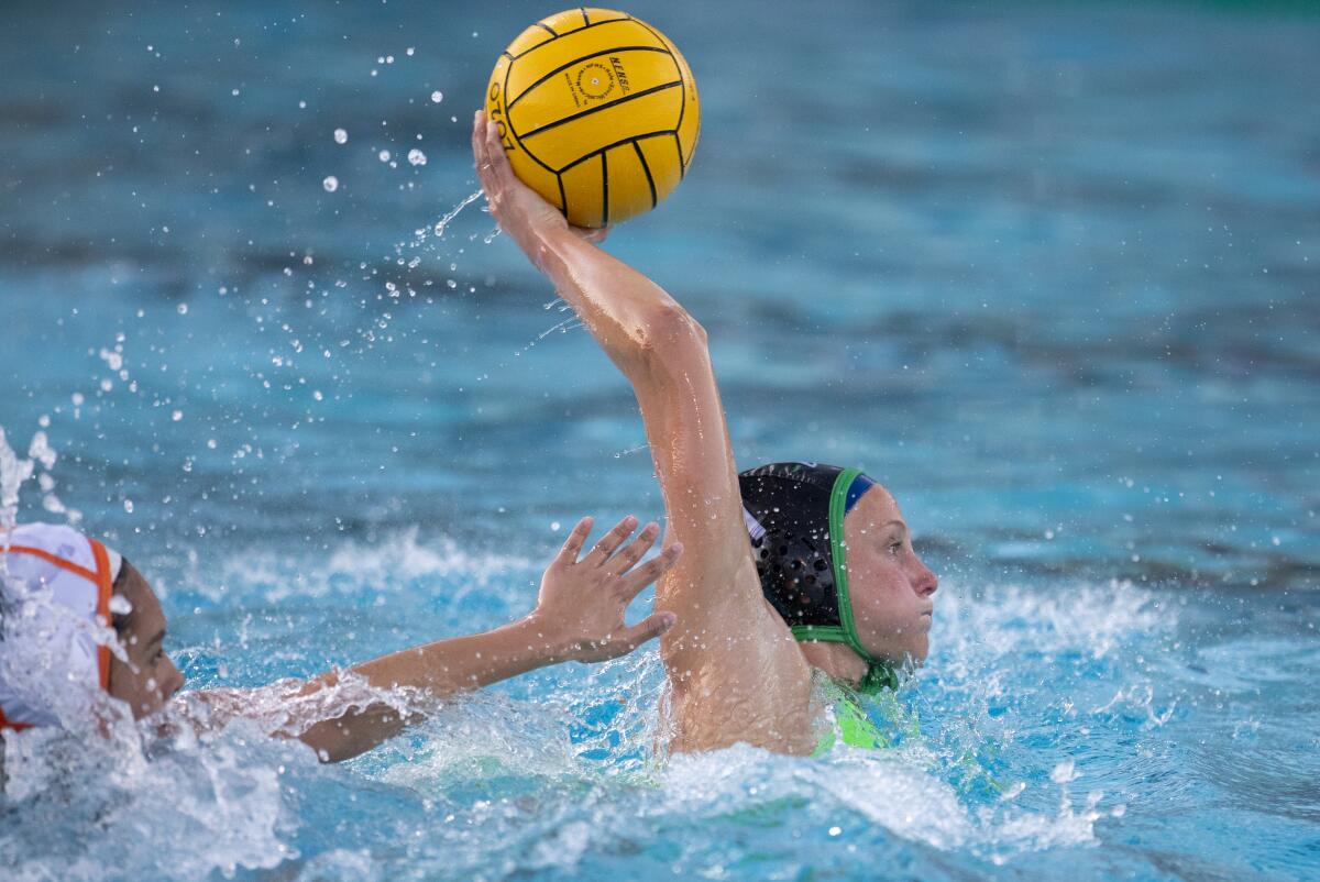 Costa Mesa's Kira Anderson takes a shot against Los Amigos' Marliyn Castillo in the first round of the CIF Southern Section Division 5 playoffs on Tuesday.