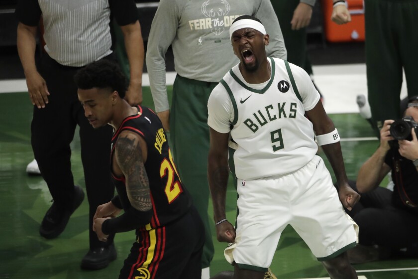 Milwaukee Bucks' Bobby Portis (9) reacts after dunking during the first half of Game 5 of the NBA Eastern Conference Finals against the Atlanta Hawks Thursday, July 1, 2021, in Milwaukee. (AP Photo/Aaron Gash)
