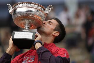 Serbia's Novak Djokovic kisses the trophy as he celebrates winning the men's singles final match of the French Open tennis tournament against Norway's Casper Ruud in three sets, 7-6, (7-1), 6-3, 7-5, at the Roland Garros stadium in Paris, Sunday, June 11, 2023. Djokovic won his record 23rd Grand Slam singles title, breaking a tie with Rafael Nadal for the most by a man. (AP Photo/Christophe Ena)