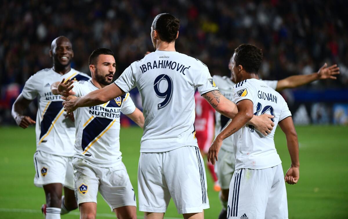 Zlatan Ibrahimovic of the LA Galaxy celebrates with teammates after his corner kick led to a goal in the second half against the New York Red Bulls in their MLS match in Carson, California on April 28, 2018.