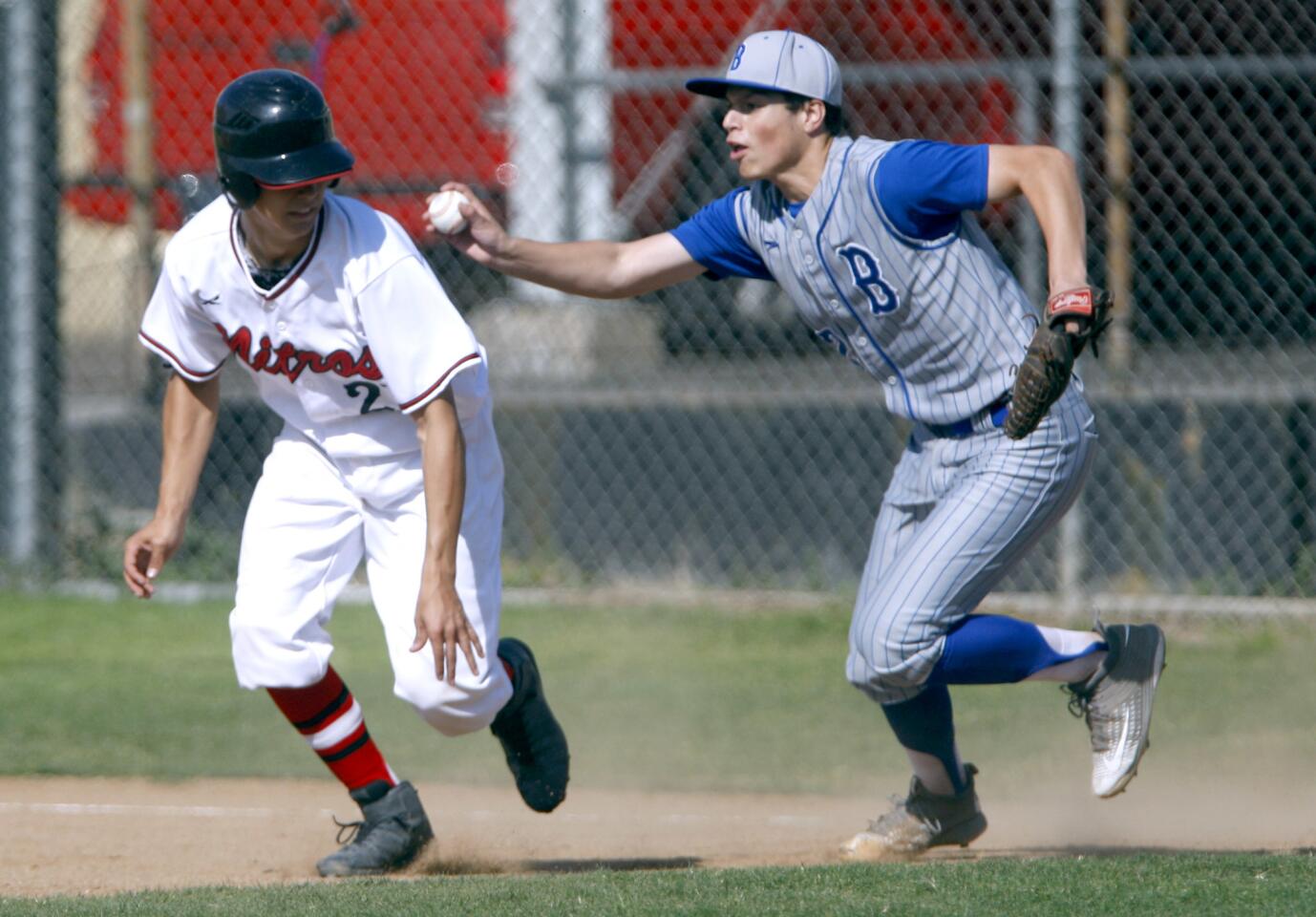 Glendale High School's #21 Armando Alvarez gets caught in a rundown between first and second base by Burbank High School pitcher #32 Lungaro (Roster had no first names, max preps only had 2 players) in home game in Glendale on Tuesday, April 4, 2017.