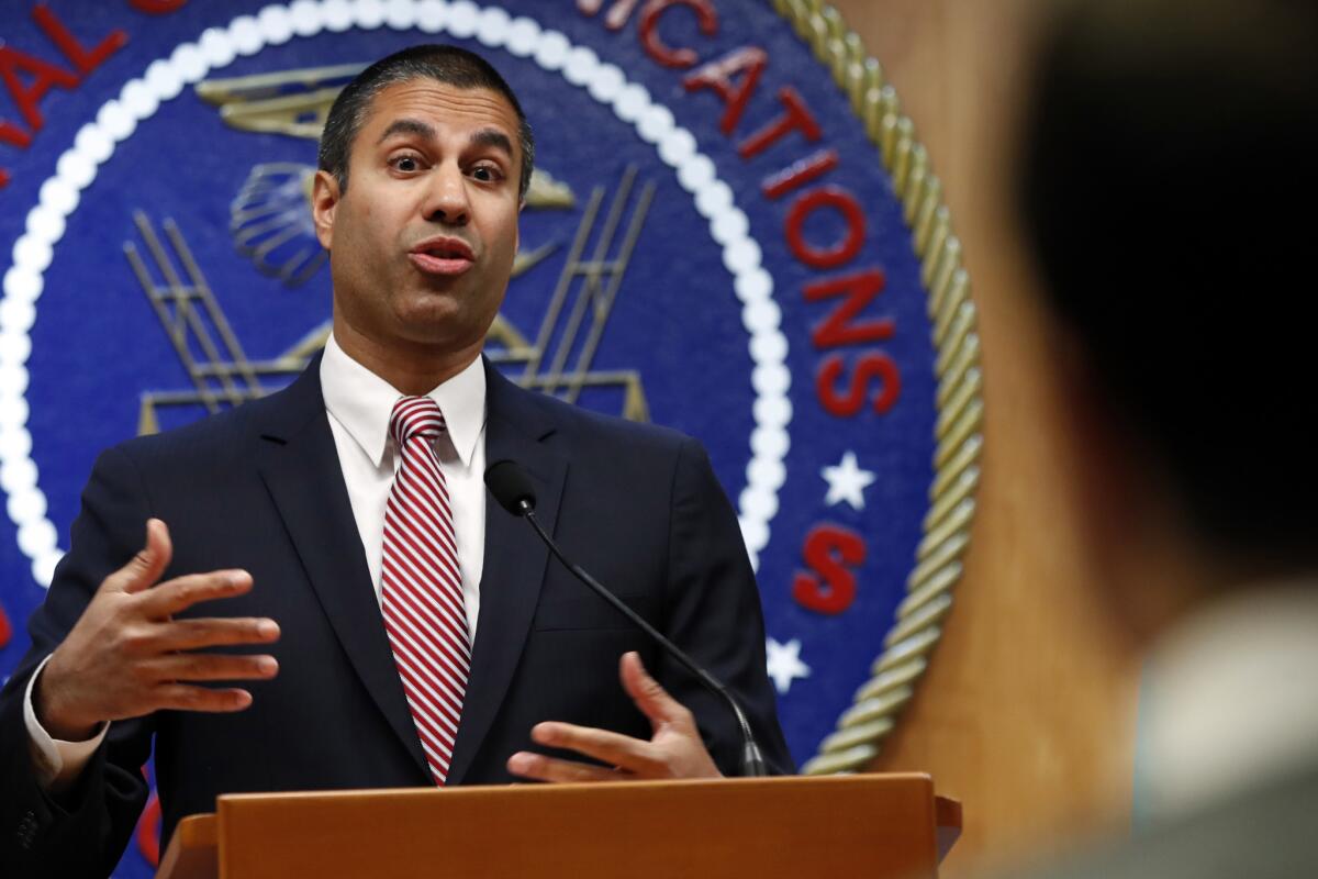 After a meeting voting to end net neutrality, Federal Communications Commission (FCC) Chairman Ajit Pai answers a question from a reporter, Thursday, Dec. 14, 2017, in Washington. On Thursday Pai and the FCC proposed a nearly $10 million find for a San Diego-based telemarketer.