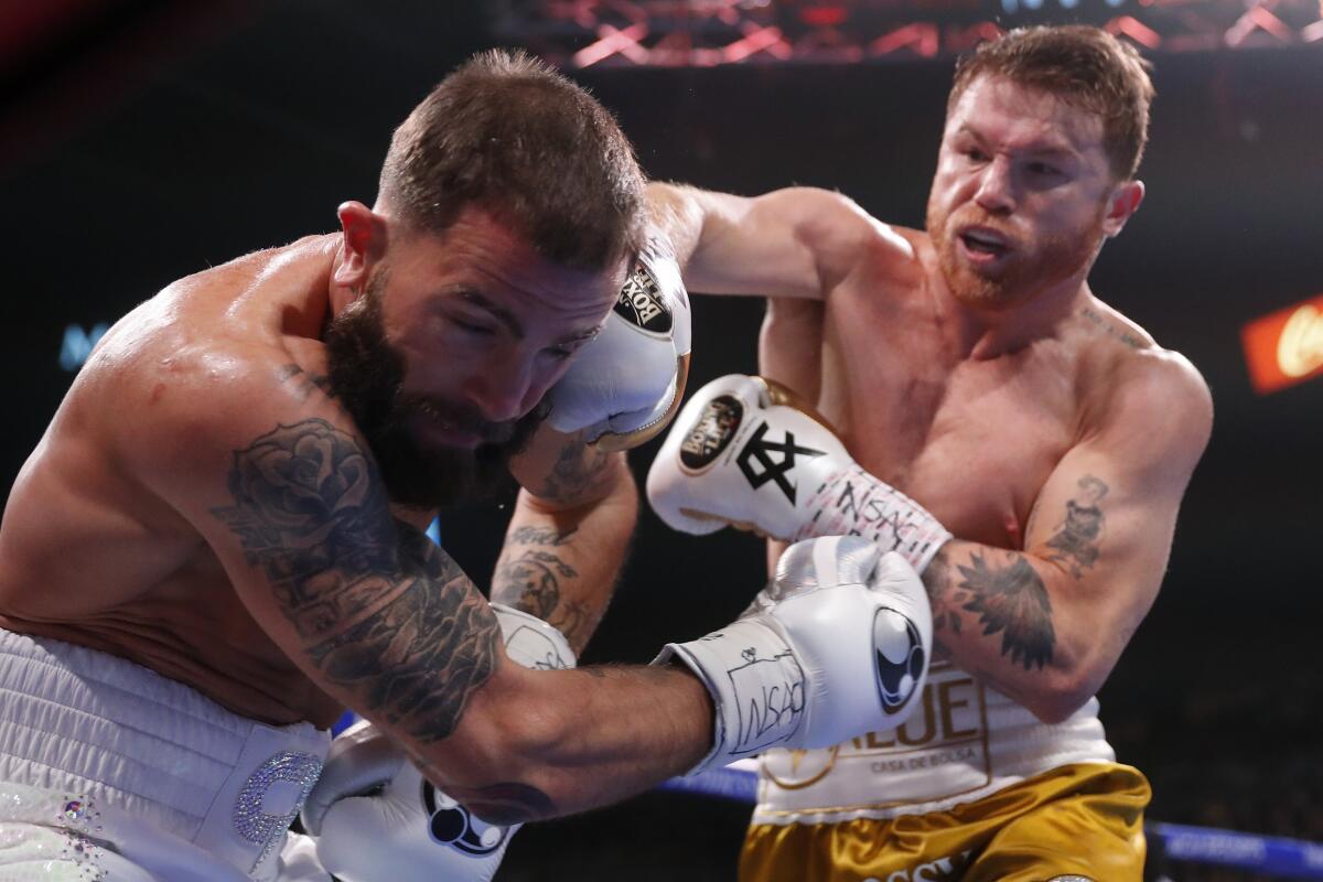 Canelo ?lvarez of Mexico punches Caleb Plant during their super middleweight title unification bout on Saturday.