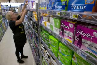 FILE - In this June 22, 2016 file photo, Tammy Compton restocks tampons at Compton's Market, in Sacramento, Calif. Bills to exempt feminine hygiene products and diapers from sales taxes were vetoed by Gov. Jerry Brown in 2016, but the measure's author's Assemblywomen Lorena Gonzalez Fletcher, D-San Diego, and Cristina Garcia, D-Bell Gardens, are reintroducing the proposals with a provision to fund their proposed sales tax exemptions with increased liquor taxes, Thursday, March 9, 2017. (AP Photo/Rich Pedroncelli, File)