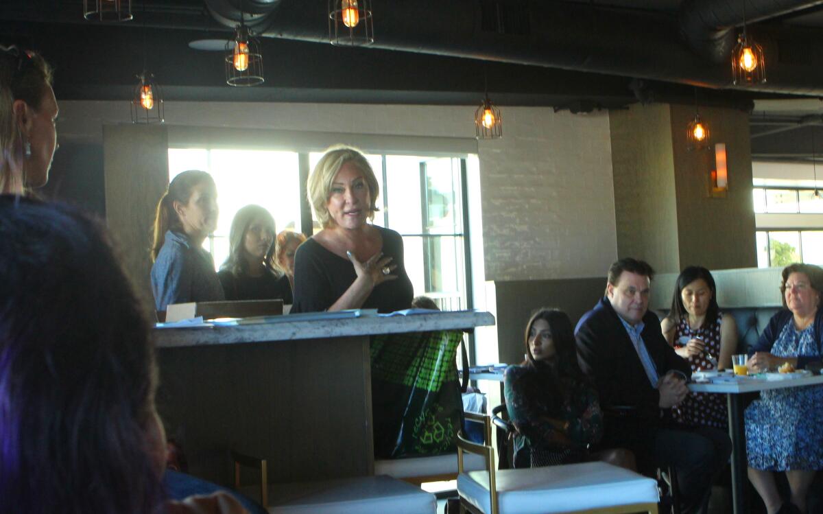 La Jolla Art & Wine Festival founder Sherry Ahern addresses a breakfast meeting of the La Jolla Village Merchants Association, Sept. 17 at Sushi on the Rock.