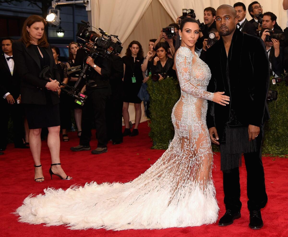 Kim Kardashian West, left, with Kanye West says the dress she is wearing at the "China: Through The Looking Glass" Costume Institute Benefit Gala at the Metropolitan Museum of Art on Monday was inspired by Cher.