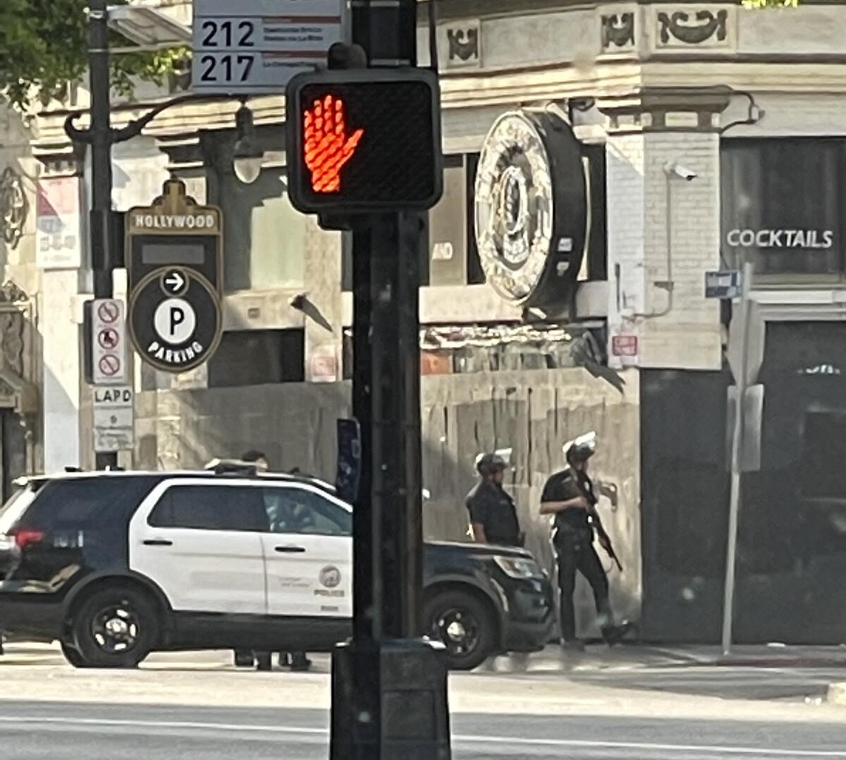 Police officers with their guns drawn.