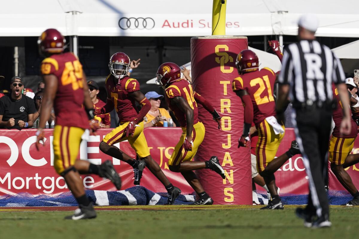 USC defensive back Calen Bullock celebrates after scoring on an interception return against Rice in the first half.