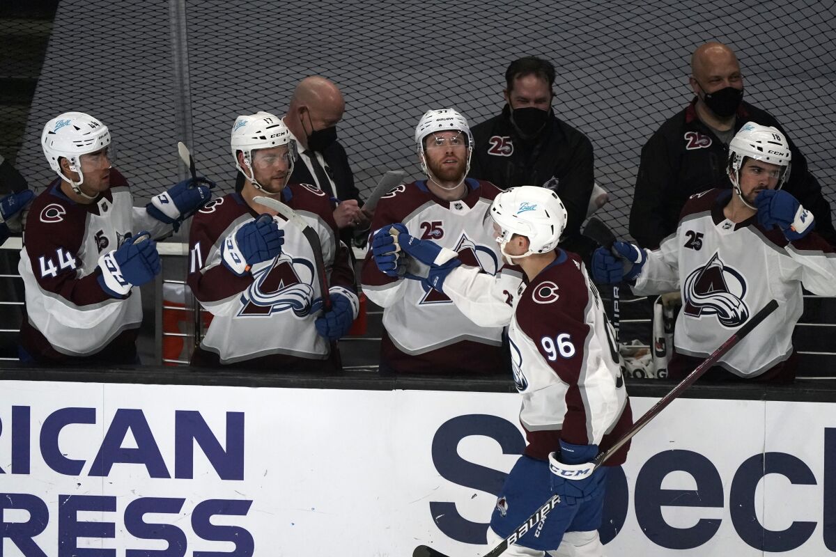 Colorado Avalanche right wing Mikko Rantanen (96) celebrates his goal with teammates on the bench during the first period of an NHL hockey game against the Los Angeles Kings Friday, May 7, 2021, in Los Angeles. (AP Photo/Marcio Jose Sanchez)
