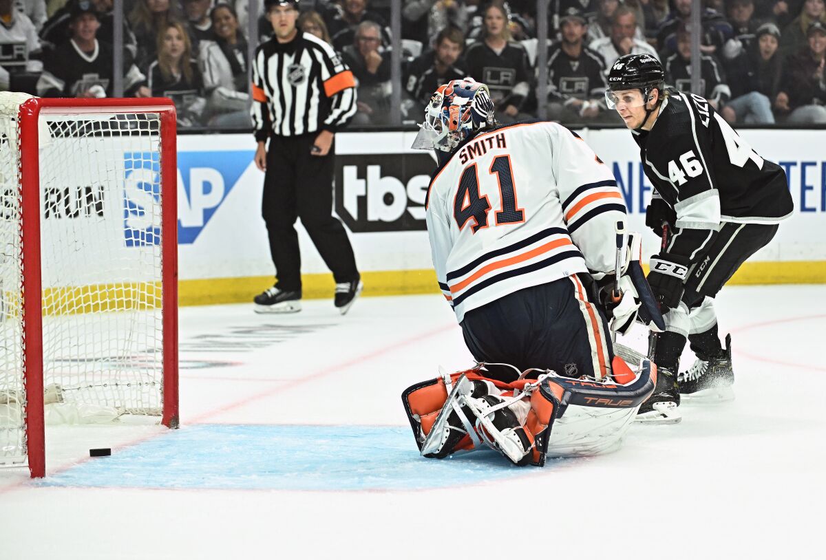 A shot by Kings defenseman Troy Stetcher (not pictured) slides past Edmonton Oilers goalie Mike Smith.