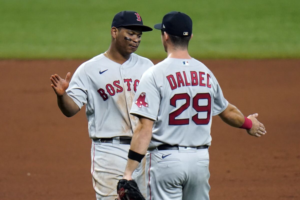 Boston Red Sox third baseman Rafael Devers, left, and first baseman Bobby Dalbec celebrate after the team defeated the Tampa Bay Rays during a baseball game Thursday, Sept. 10, 2020, in St. Petersburg, Fla. (AP Photo/Chris O'Meara)