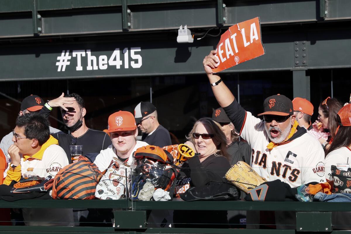 San Francisco Giants fans watch warm ups before game five of the 2021 National League Division Series.