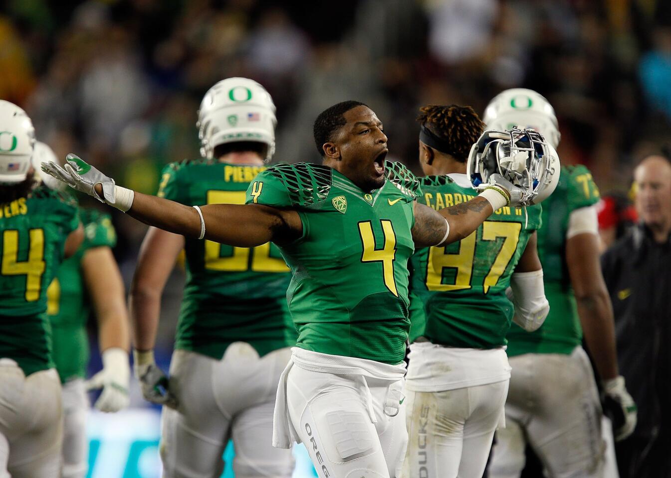Oregon defensive back Erick Dargan turns toward fans and celebrates during the Ducks' 51-13 victory over the Arizona Wildcats in the Pac-12 Conference championship game on Friday night at Levi's Stadium in Santa Clara.