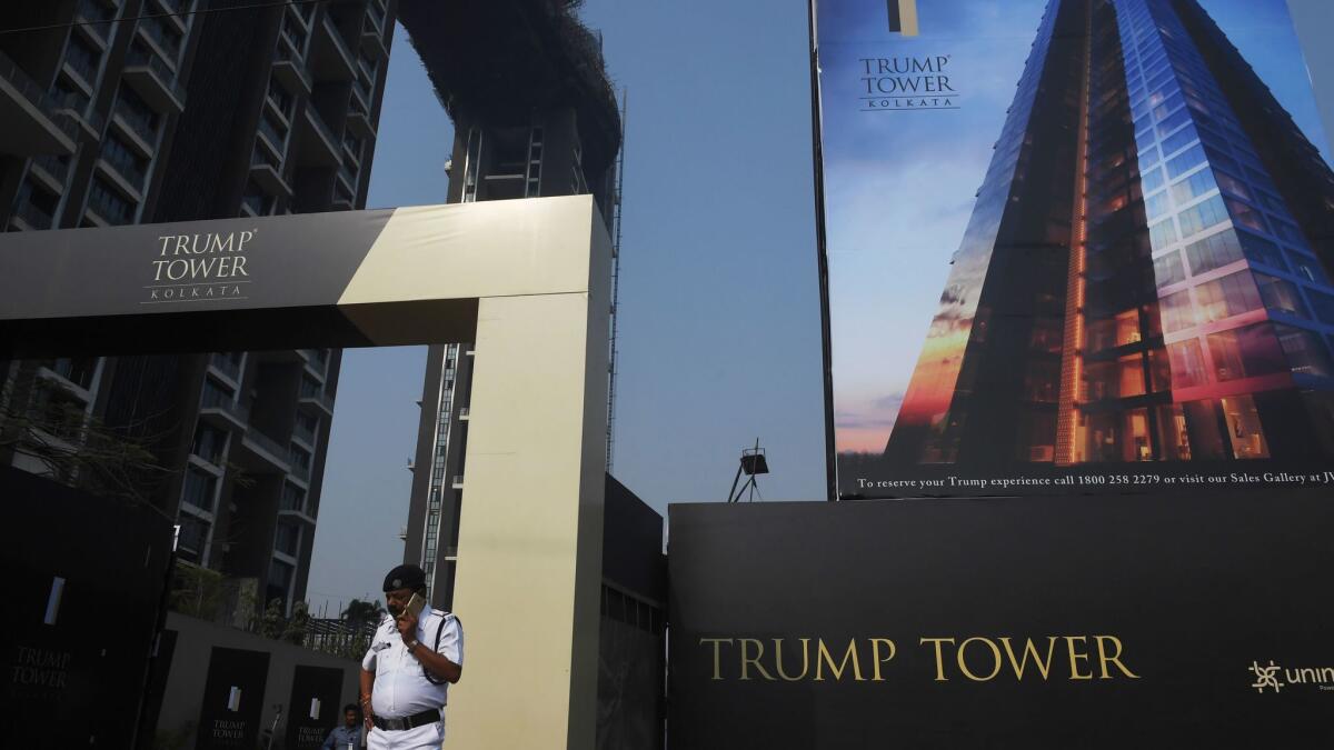 An Indian security official stands at the entrance to the Trump Tower construction site in Kolkata, India.