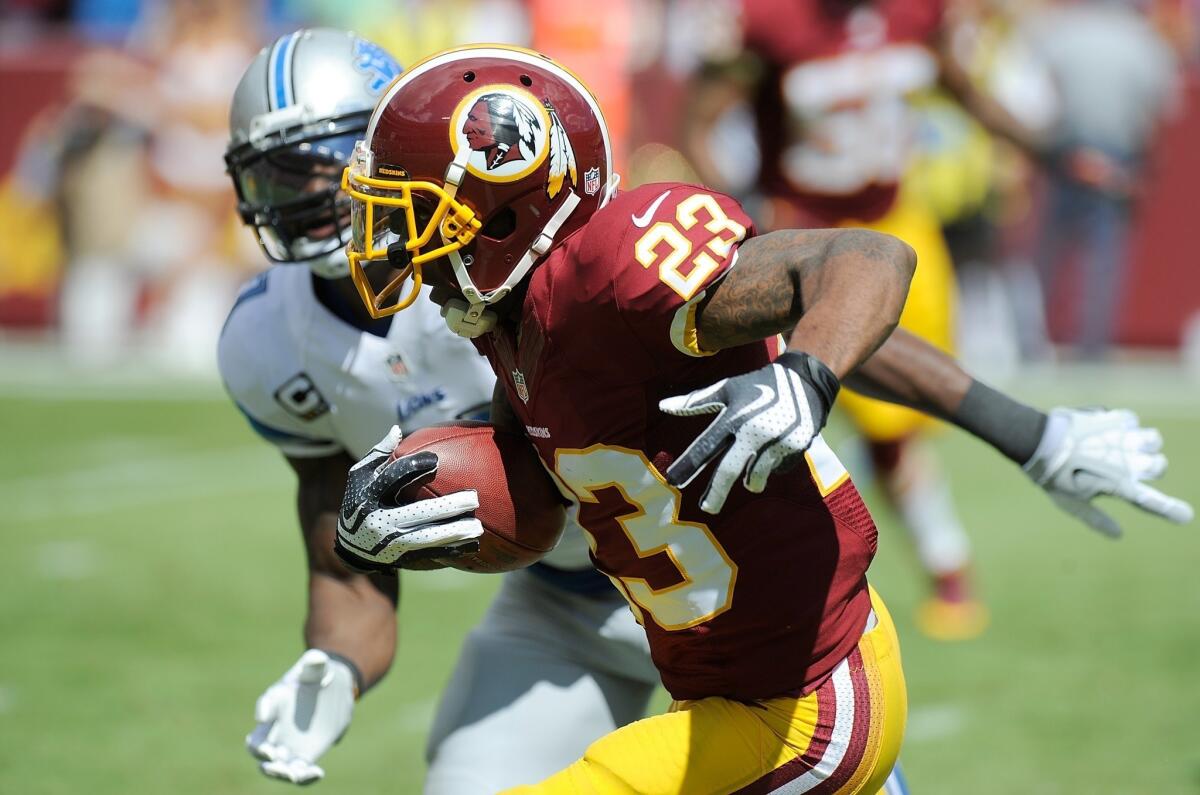 Washington cornerback DeAngelo Hall was chided by an NFL wardrobe inspector for wearing a Lacoste shirt during a postgame interview on Sunday. Above, in the Redskins' game the previous week, Hall returns an interception for a touchdown against the Lions.