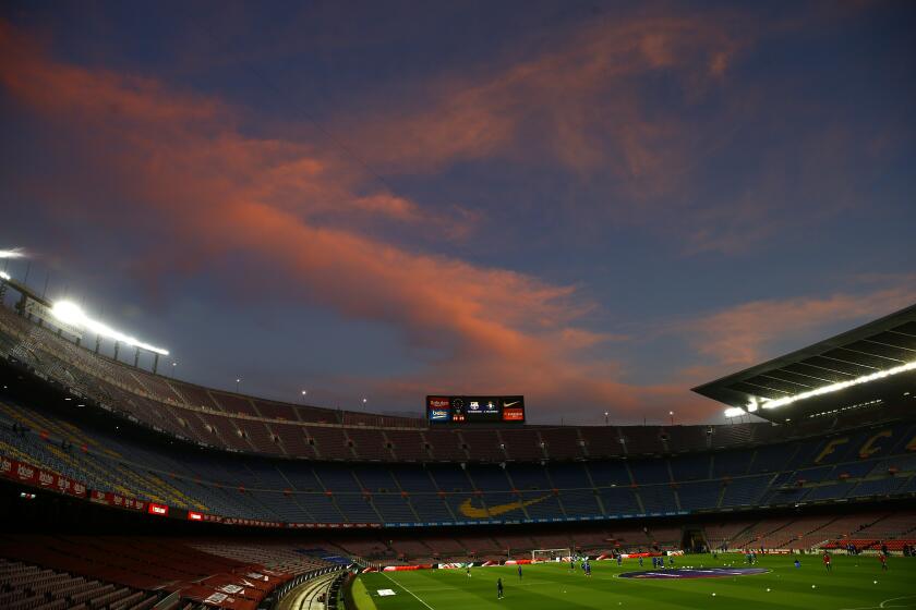 FILE - A general view of the the Camp Nou stadium as the sun sets ahead of the Spanish La Liga soccer match between FC Barcelona and Valladolid CF in Barcelona, Spain, on April 5, 2021. Spanish police raided offices of the Spanish soccer federation on Thursday Sept. 28, 2023 as part of a judicial investigation into the alleged payment of millions of euros over several years by Barcelona soccer club to the vice president of Spain’s football refereeing committee. (AP Photo/Joan Monfort, File)