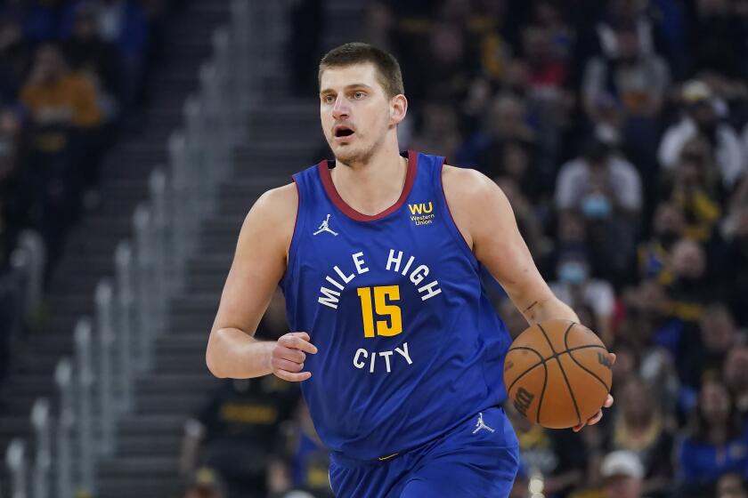 FILE - Denver Nuggets center Nikola Jokic (15) dribbles the ball up the court against the Golden State Warriors during the first half of Game 2 of an NBA basketball first-round playoff series in San Francisco, Monday, April 18, 2022. Jokic has won his second consecutive Most Valuable Player award after a season in which he finished with numbers never before seen in NBA history, a person familiar with the decision told The Associated Press on Monday, May 9, 2022. (AP Photo/Jeff Chiu, File)