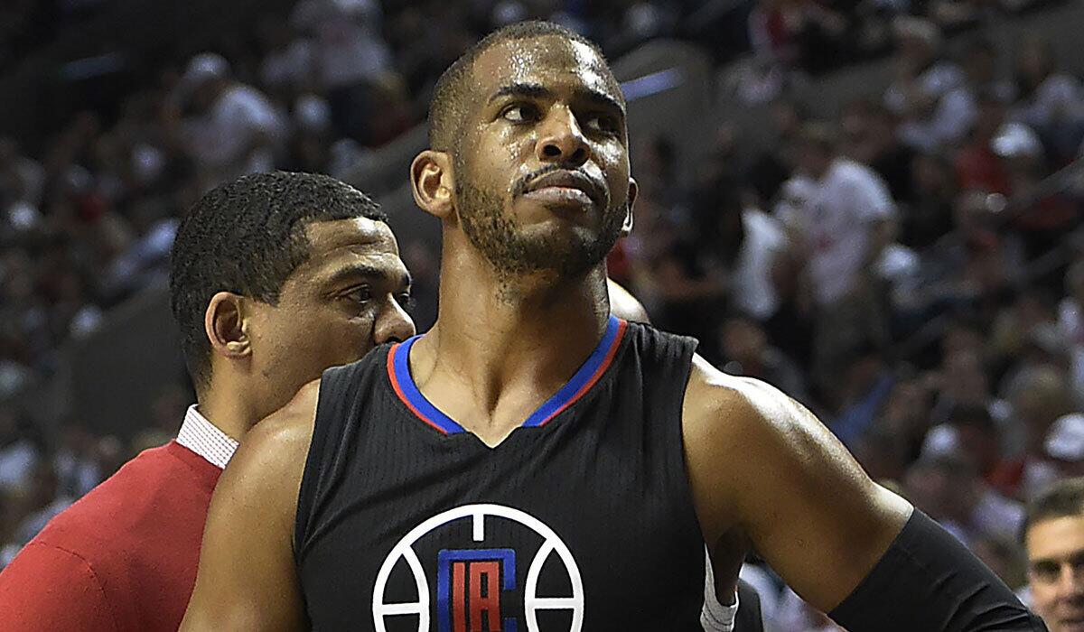 The Clippers' Chris Paul walks off the court on Monday after injuring his hand in Game Four of the Western Conference Quarterfinals against the Portland Trail Blazers in Oregon. The Blazers won the game 98-84.
