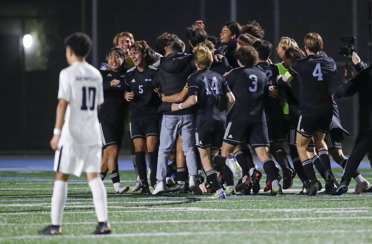 Corona del Mar players celebrate a win in the Battle of the Bay boys' soccer game against Newport Harbor on Monday.