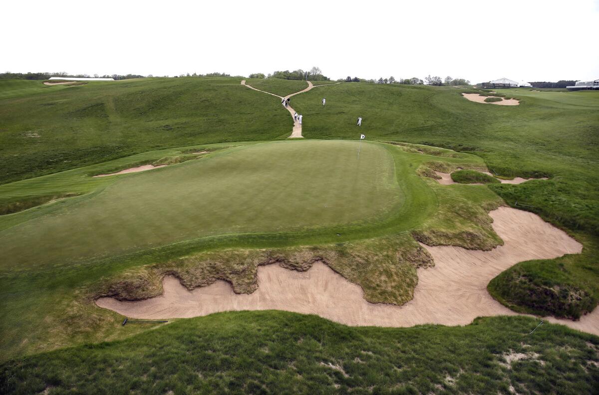Golfers approach the ninth hole at Erin Hills, which sits on more than 650 acres of Wisconsin farmland.