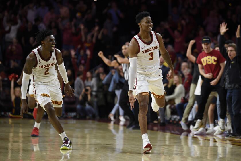 Southern California guard Elijah Weaver, right, celebrates after making a three-point shot to tie the game to force overtime during the second half of an NCAA college basketball game as Jonah Mathews jumps to celebrate against Stanford in Los Angeles, Saturday, Jan. 18, 2020. Southern California won 82-78. (AP Photo/Kelvin Kuo)