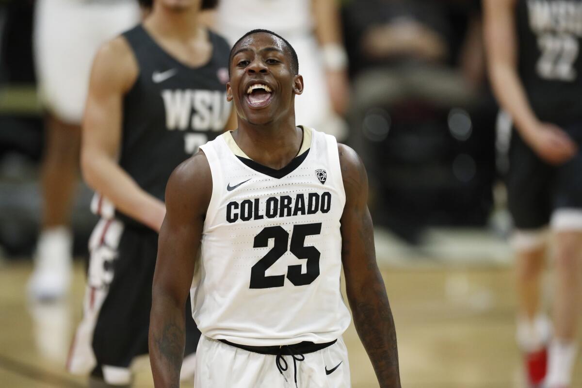 FILE - Colorado guard McKinley Wright IV jokes with teammates as he heads to the bench late in the second half of an NCAA college basketball game against Washington State, in this Thursday, Jan. 23, 2020, file photo taken in Boulder, Colo. Wright, a Minnesota native, will return to play in his senior year at Colorado. (AP Photo/David Zalubowski, File)