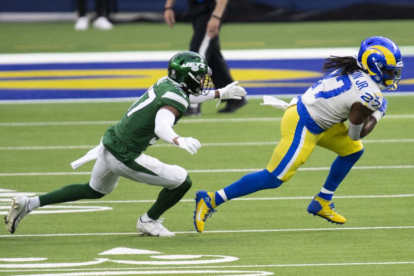 Los Angeles Rams running back Darrell Henderson Jr. (27), right, sprints with the ball past New York Jets cornerback Bryce Hall (37) during an NFL football game Sunday, Dec. 20, 2020, in Inglewood, Calif. (AP Photo/Kyusung Gong)