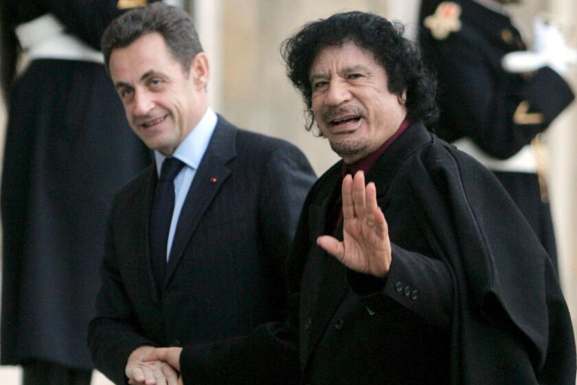 Mandatory Credit: Photo by MAYA VIDON/EPA-EFE/REX/Shutterstock (9471172a) Nicolas Sarkozy and Muammar Gaddafi Nicolas Sarkozy in police custody, Paris, France - 12 Dec 2007 (FILE) - French President Nicolas Sarkozy (L) welcomes Libyan leader Muammar Gaddafi at Palais Elysee, Paris, France, 12 December 2007, (reissued 20 March 2018). Media reports on 20 March 2018 state that former French president is being questioned in connection to alleged Libyan financing for his 2007 election campaign. ** Usable by LA, CT and MoD ONLY **