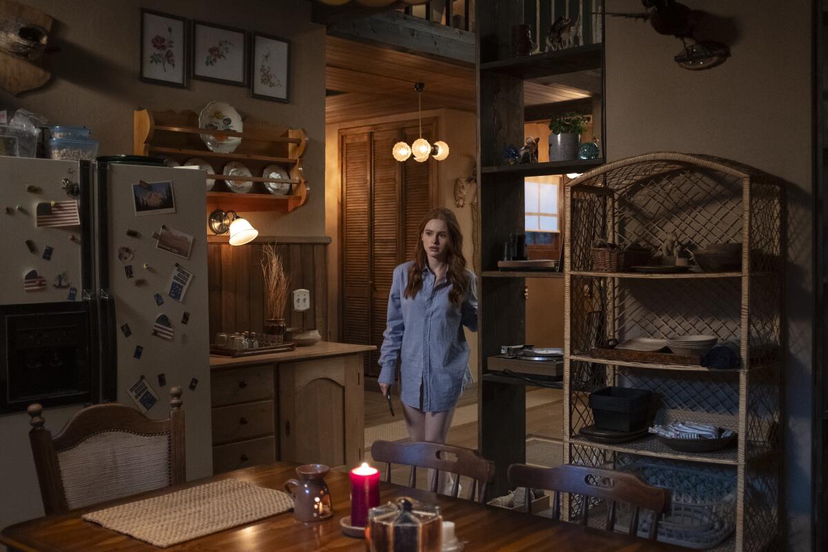 Madelaine Petsch stands in a kitchen in "The Strangers - Chapter 1."