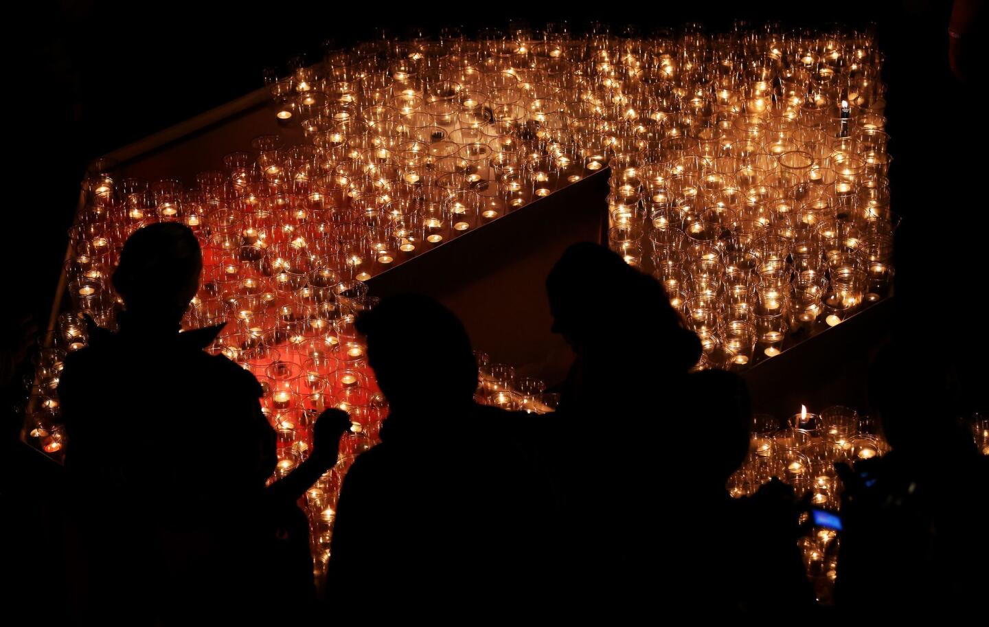 Germany began the 25th anniversary of the Berlin Wall's demise in Leipzig, where an Oct. 9, 1989, protest led to the populist effort to pull the wall down. People lighted candles Thursday in Leipzig's Augustplatz square to celebrate the protests that led to freedom.