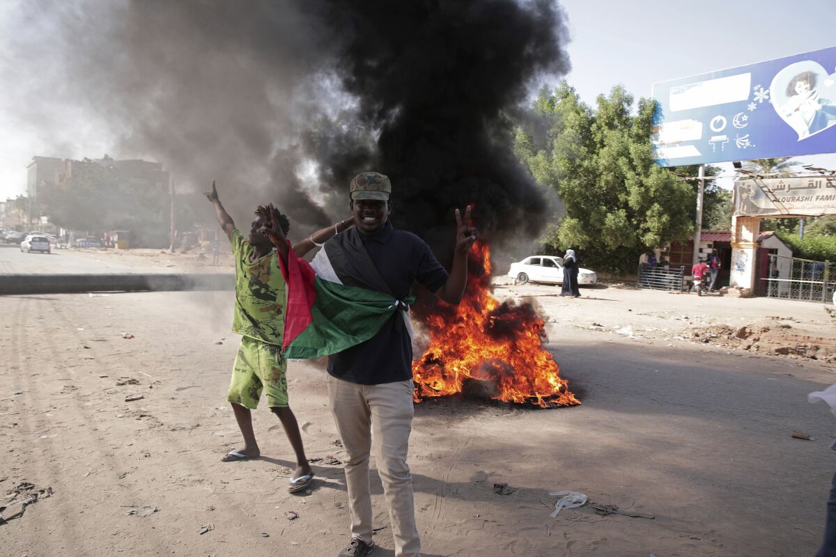 Protesters call for a civilian government during demonstrations near the presidential palace in Khartoum, Sudan, Tuesday, Nov. 30, 2021. Security forces have fired tear gas at anti-coup protesters in the Sudanese capital on Tuesday, in the latest demonstrations against a military takeover that took place last month. (AP Photo/Marwan Ali)