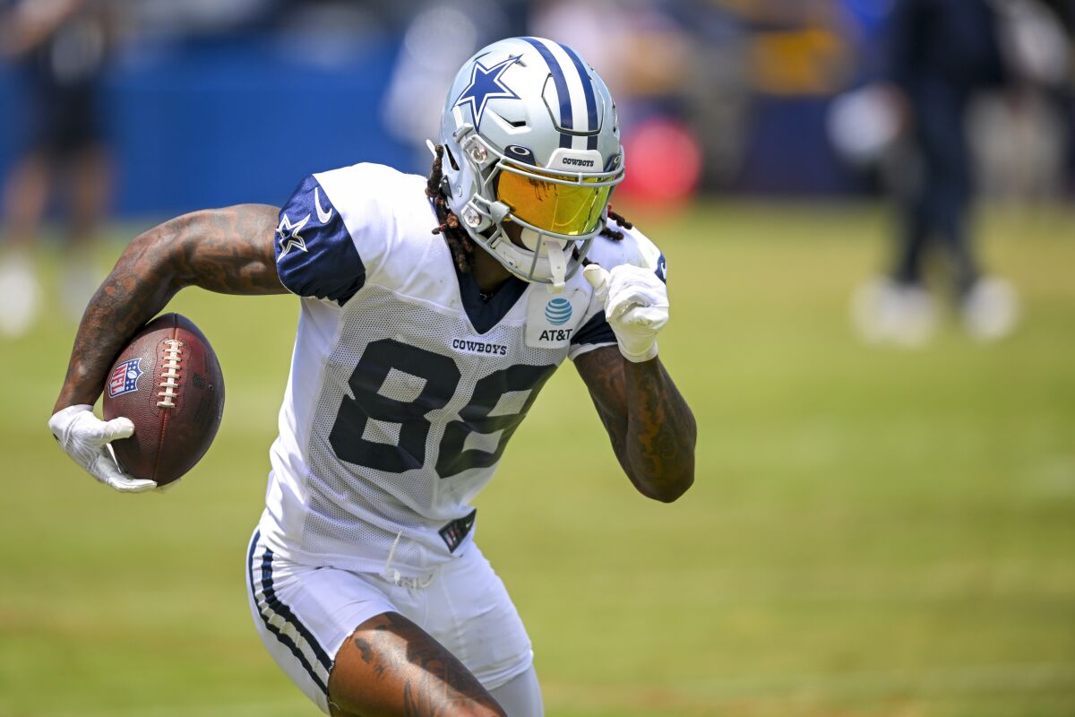 FILE - Dallas Cowboys wide receiver CeeDee Lamb runs with the ball after making a reception during NFL football training camp, Monday, Aug. 1, 2022, in Oxnard, Calif. Lamb is ready to be the No. 1 receiver for the Cowboys. (AP Photo/Gus Ruelas, File)