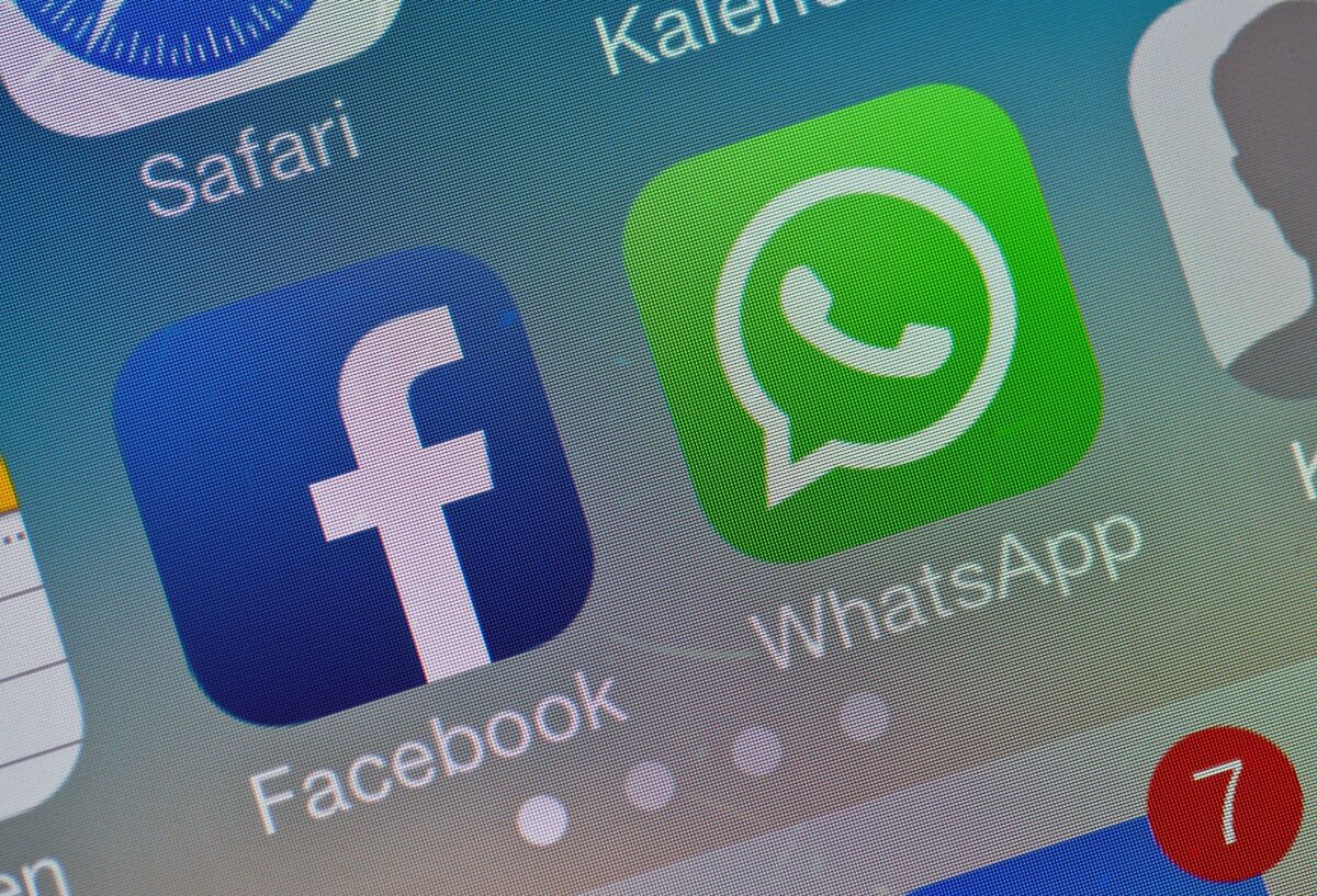 The two logos of Facebook and WhatsApp pictured on the screen of a smartphone.