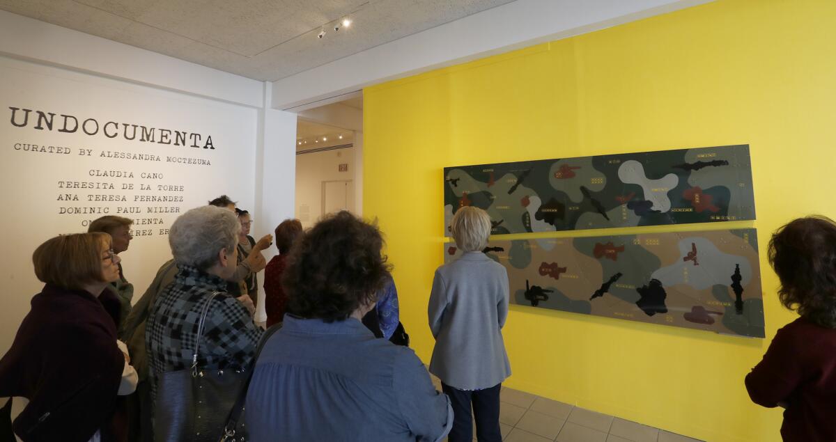 An audience gathers at the exhibition "UnDocumenta" at the Oceanside Museum of Art.