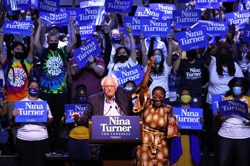 CLEVELAND, OHIO - JULY 31: Sen. Bernie Sanders (I-VT) raises the hand of Congressional Candidate Nina Turner during a Get Out the Vote rally at Agora Theater & Ballroom on July 31, 2021 in Cleveland, Ohio. Congressional Candidate Nina Turner was joined by Sen. Bernie Sanders (I-VT), Minnesota Attorney General Keith Ellison, and Dr. Cornell West for a GOTV campaign rally on the final weekend of early voting before Tuesdays Primary Special Election for Ohio's 11th Congressional District primary were Turner and Cuyahoga Councilwoman Shontel Brown are the frontrunners ahead of 11 other Democratic candidates in the race. The rally was followed by a march to the Board of Elections office. The special election was triggered after former Rep. Marcia Fudge, joined the Biden administration to become the U.S. Secretary of Housing and Urban Development. (Photo by Michael M. Santiago/Getty Images)