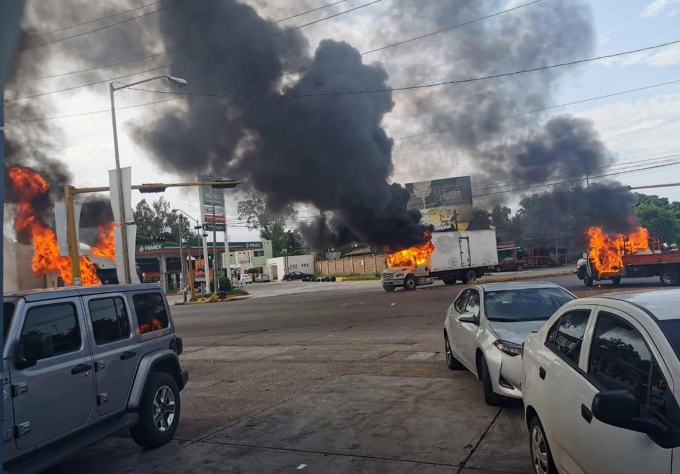 Mandatory Credit: Photo by STR/EPA-EFE/REX (10449104a) A view of vehicles on fire during a clash between armed gunmen and Federal police and military soldiers, in the streets of the city of Culiacan, Sinaloa state, Mexico, 17 October 2019. According to media reports, alleged drug cartel gunmen set up blockades and unleashed volleys of gunfire in the Mexican city of Culiacan amid rumors of the capture of Ovidio Guzman Lopez, son of imprisoned drug trafficker Joaquin 'El Chapo' Guzman Loera. The blockades set up by the gunmen, presumably from the Sinaloa drug cartel, extended to the exits of the city. Attempted capture of Ovidio Guzman Lopez sparks gunbattle in Culiacan, Mexico - 17 Oct 2019 ** Usable by LA, CT and MoD ONLY **