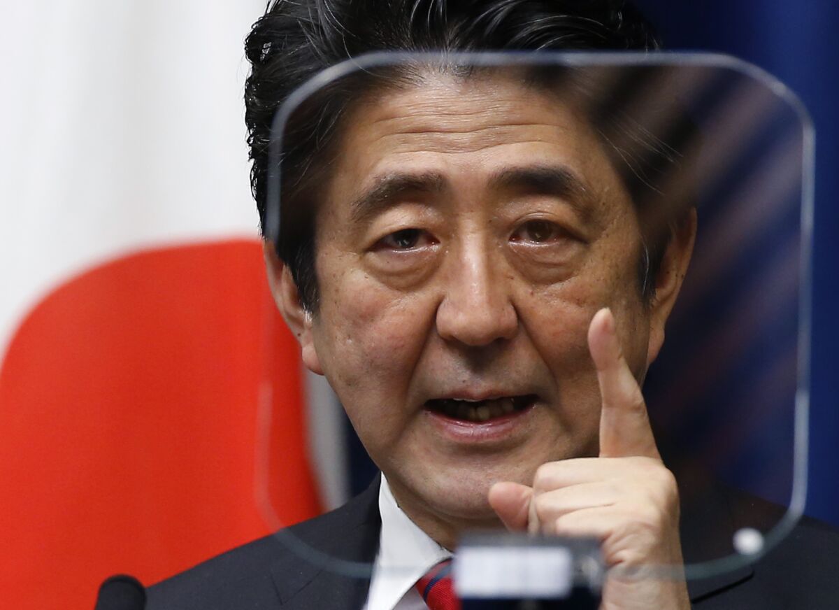 Former Japanese Prime Minister Shinzo Abe pointing his finger