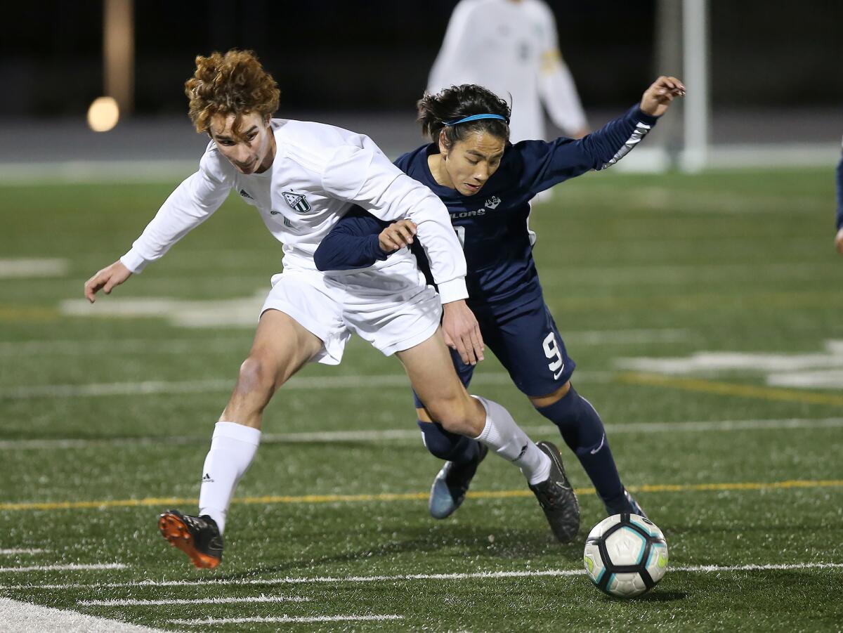 Edison’s Luke Slavik, left, and Newport Harbor’s Kaito Zaitsu battle for the ball during a Surf League match on Wednesday in Newport Beach.