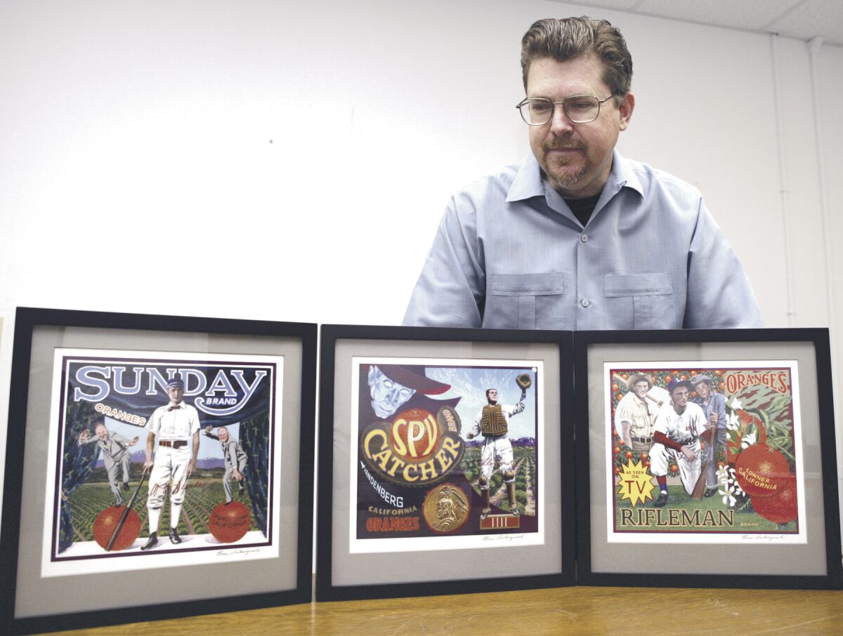 Terry Cannon, of the Baseball Reliquary, looks over some of Pasadena artist Ben Sakoguchi's work.