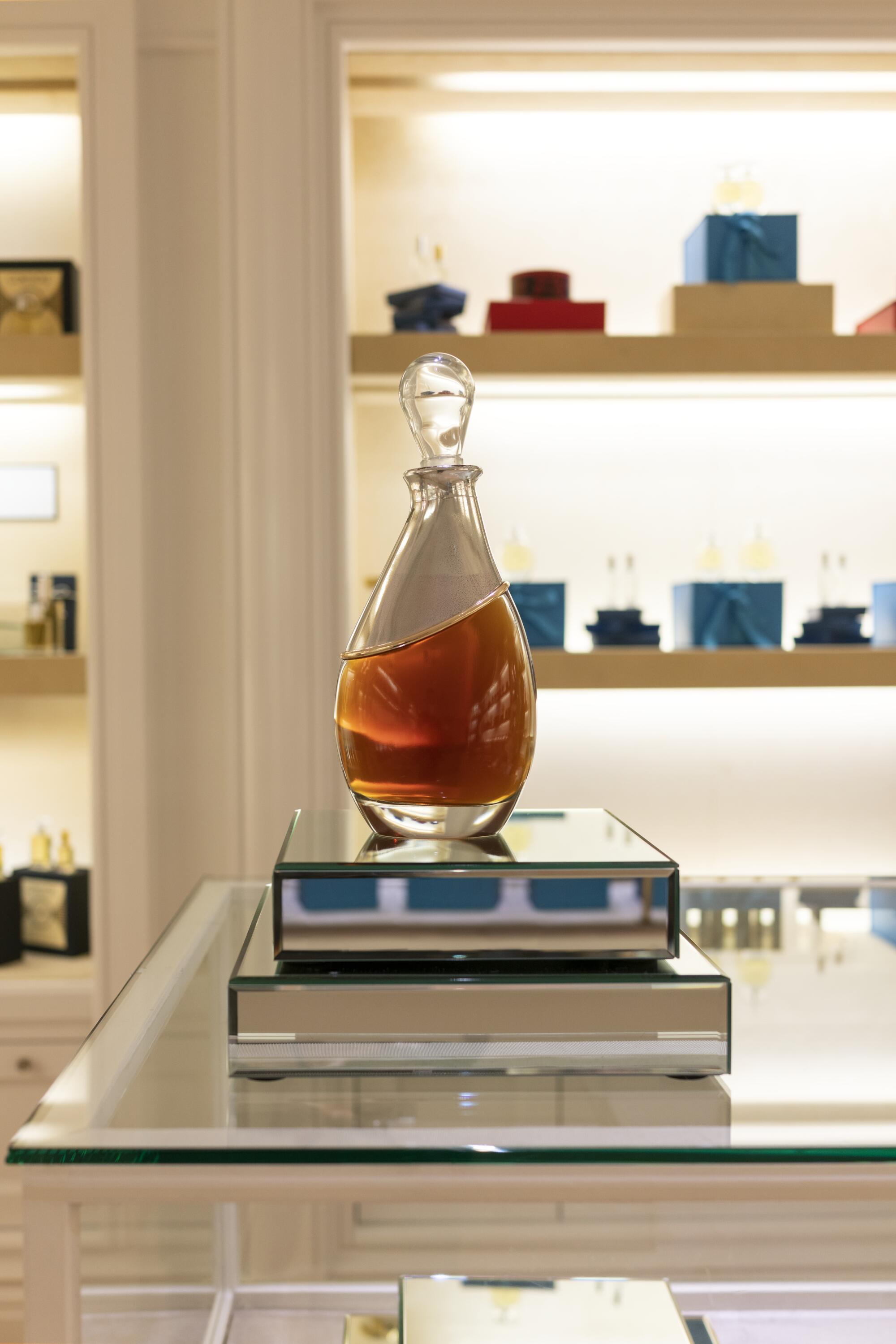 A glass perfume bottle on display in a store