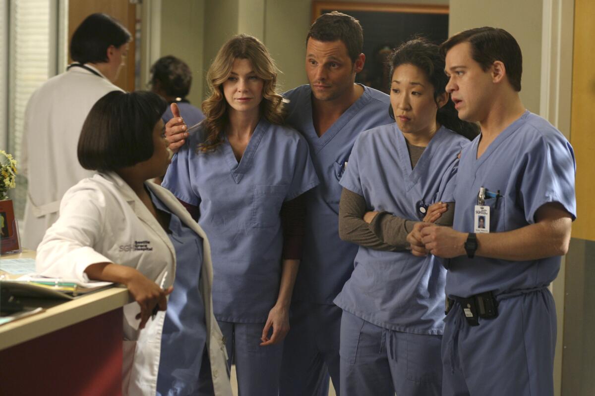 A group of surgeons wearing scrubs appear in a medical TV show.