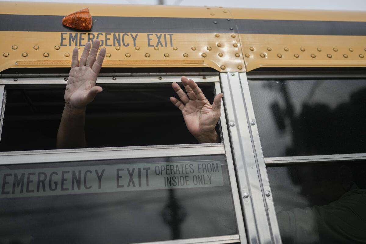 Nicaraguan citizens wave from a bus after being released from a Nicaraguan prison.