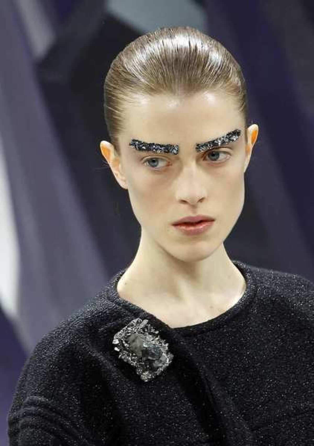 A model with bejeweled brows in a look from Chanel during Paris Fashion Week.