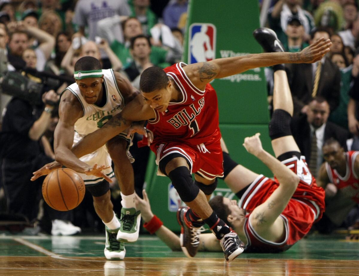 Derrick Rose and the Celtics' Rajon Rondo battle for ball in 4th quarter during Bulls' 105-103 overtime win during Game 1 of Eastern Conference quarterfinals. (Scott Strazzante / Chicago Tribune)