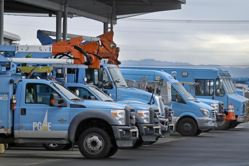 FILE - In this Jan. 14, 2019, file photo, Pacific Gas & Electric vehicles are parked at the PG&E Oakland Service Center in Oakland, Calif. Pacific Gas & Electric said it will shut off power Saturday, June 8, to about 1,600 customers in Northern California and may do the same for thousands more to reduce the risk of wildfires. The utility announced Friday night that as of Saturday morning it will turn off electricity to customers in Napa, Solano and Yolo counties west of Sacramento. (AP Photo/Ben Margot, File)