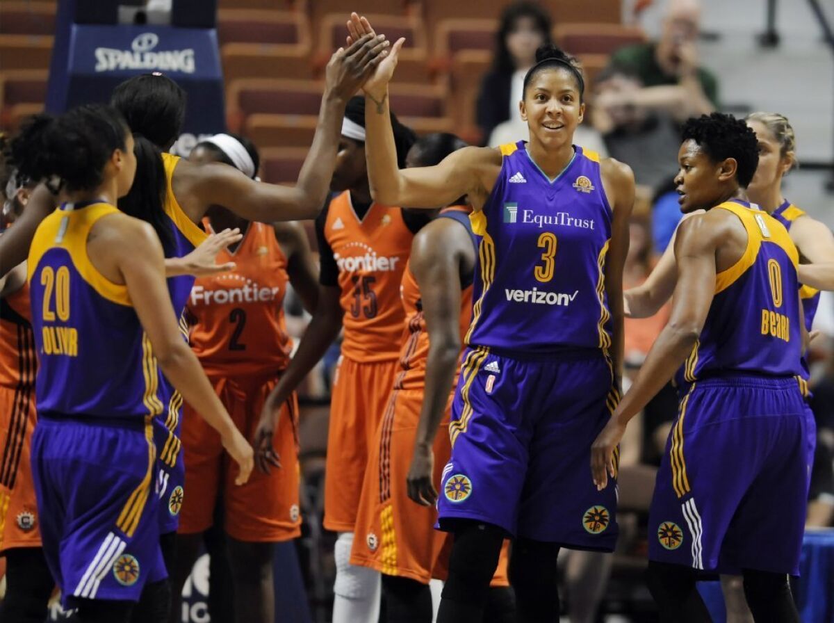Candace Parker high-fives Nneka Ogwumike during the first half of the Sparks' 77-72 win over the Sun on May 26.