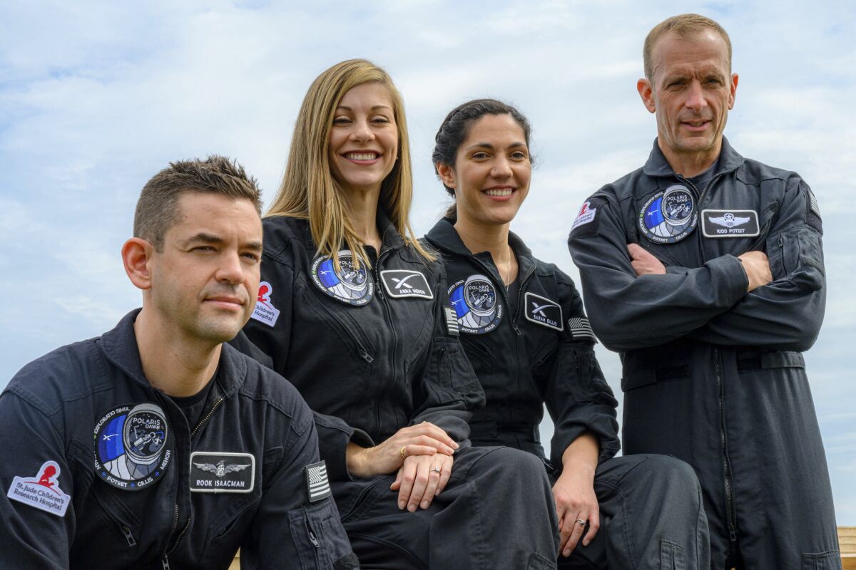 This image provided by Polaris shows, from left, Tech entrepreneur Jared Isaacman, SpaceX employees Anna Menon and Sarah Gillis and Scott Poteet, a retired Air Force lieutenant colonel. The billionaire who flew on his own SpaceX flight last year is headed back up, aiming for an even higher orbit. Isaacman announced Monday, Feb. 14, 2022 that he will make another private spaceflight launching from NASA's Kennedy Space Center. Plans call for Isaacman and the three others, including two SpaceX engineers, to blast off aboard a Falcon rocket no earlier than November on a five-day trip. (John Kraus/Polaris via AP)
