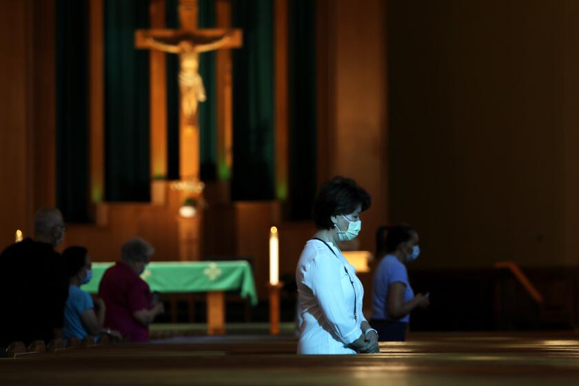 SAN GABRIEL-CA-JULY 12, 2020: Parishioners attend mass at San Gabriel Mission Church in San Gabriel on Sunday, July 12, 2020. A fire caused "extensive damage" to the historic 249-year-old San Gabriel Mission Saturday. (Christina House / Los Angeles Times)